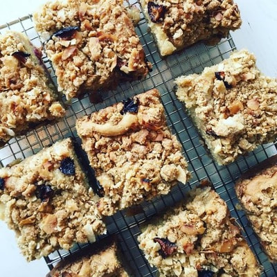 Eight flapjacks sit on a cooling rack.